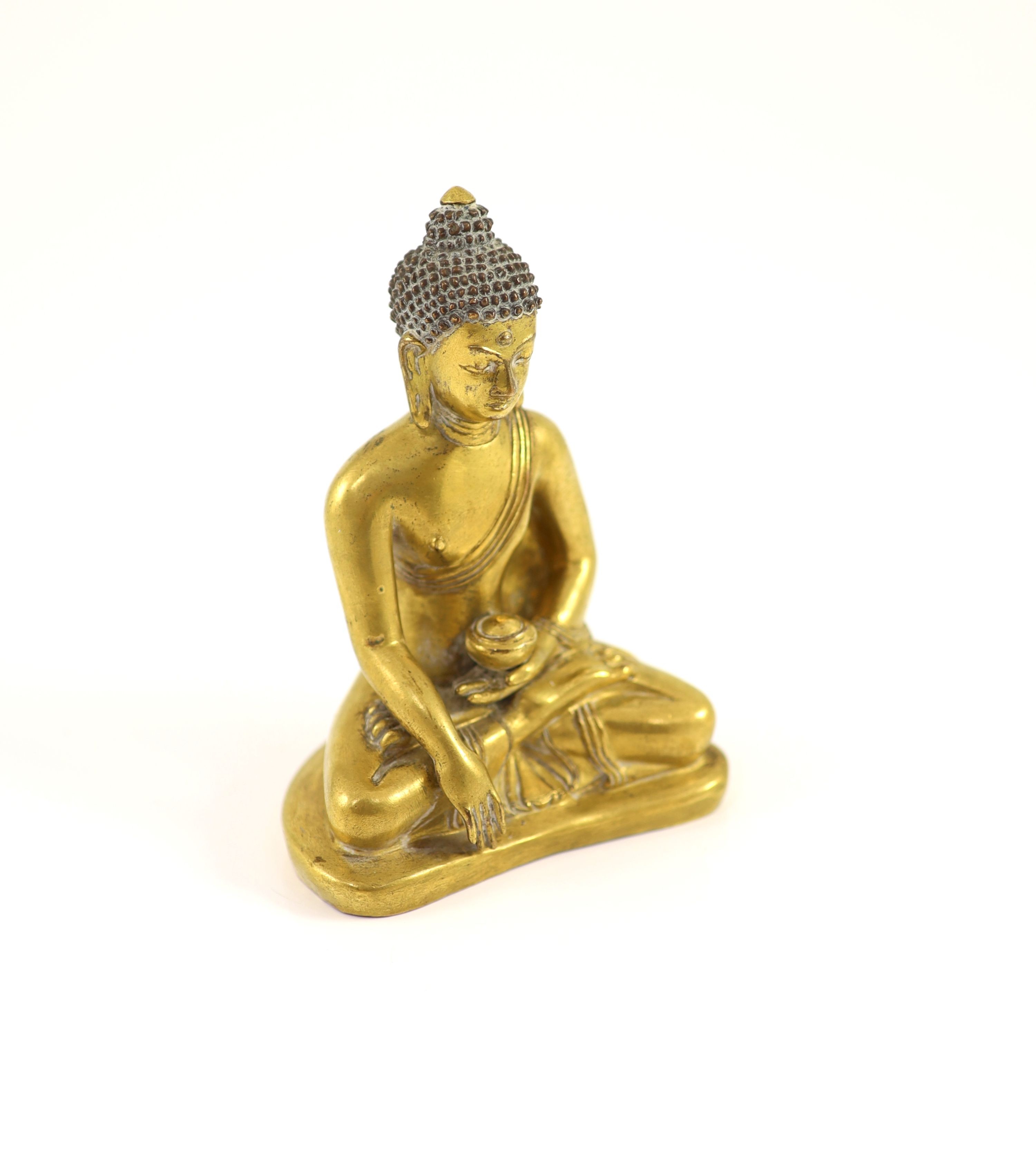 A Tibetan gilt copper alloy seated figure of Buddha Shakyamuni, 18th century, 13cm high